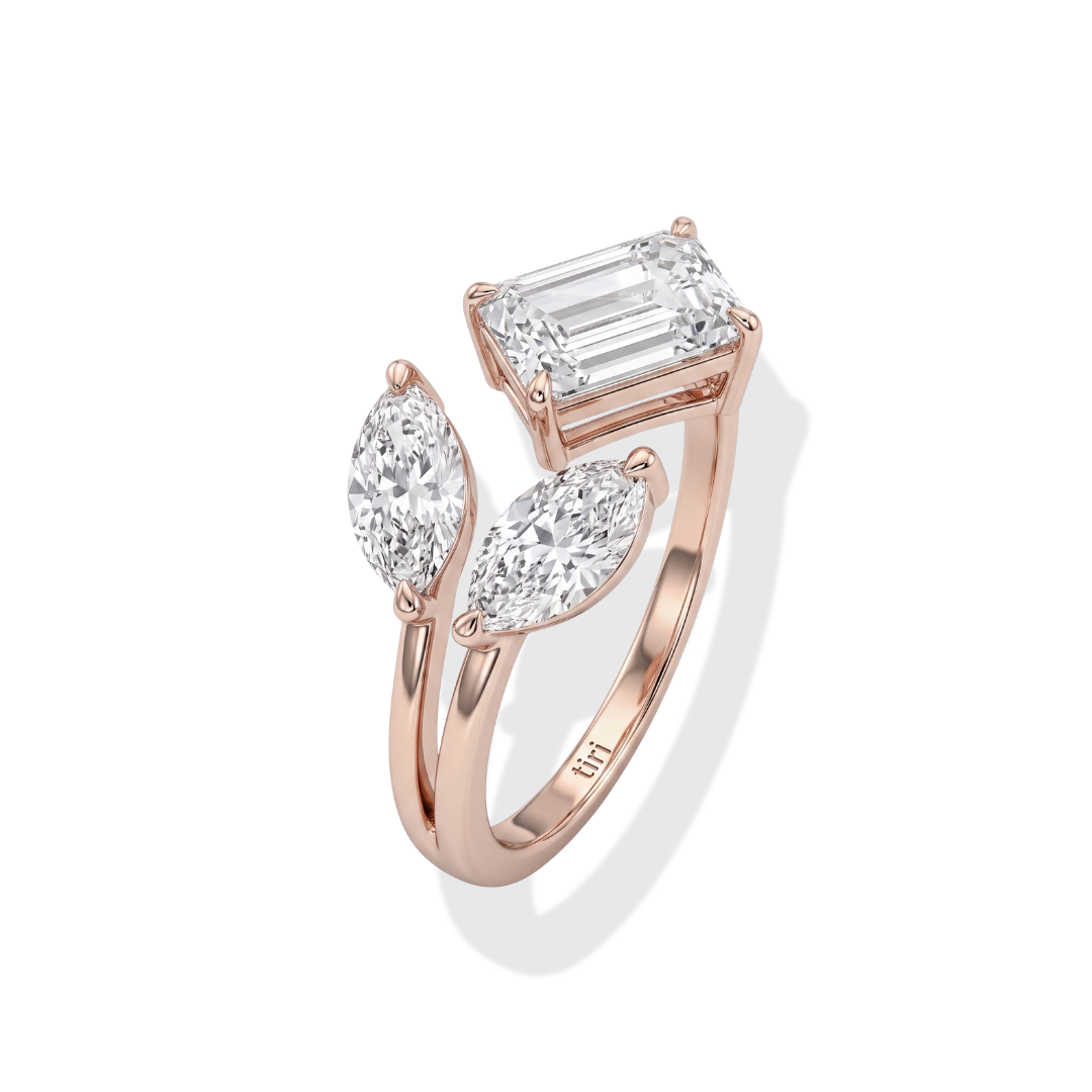 Tiri Marquise and Emerald Duo Diamond Ring featuring a marquise-cut diamond and emerald accents on a sleek band.