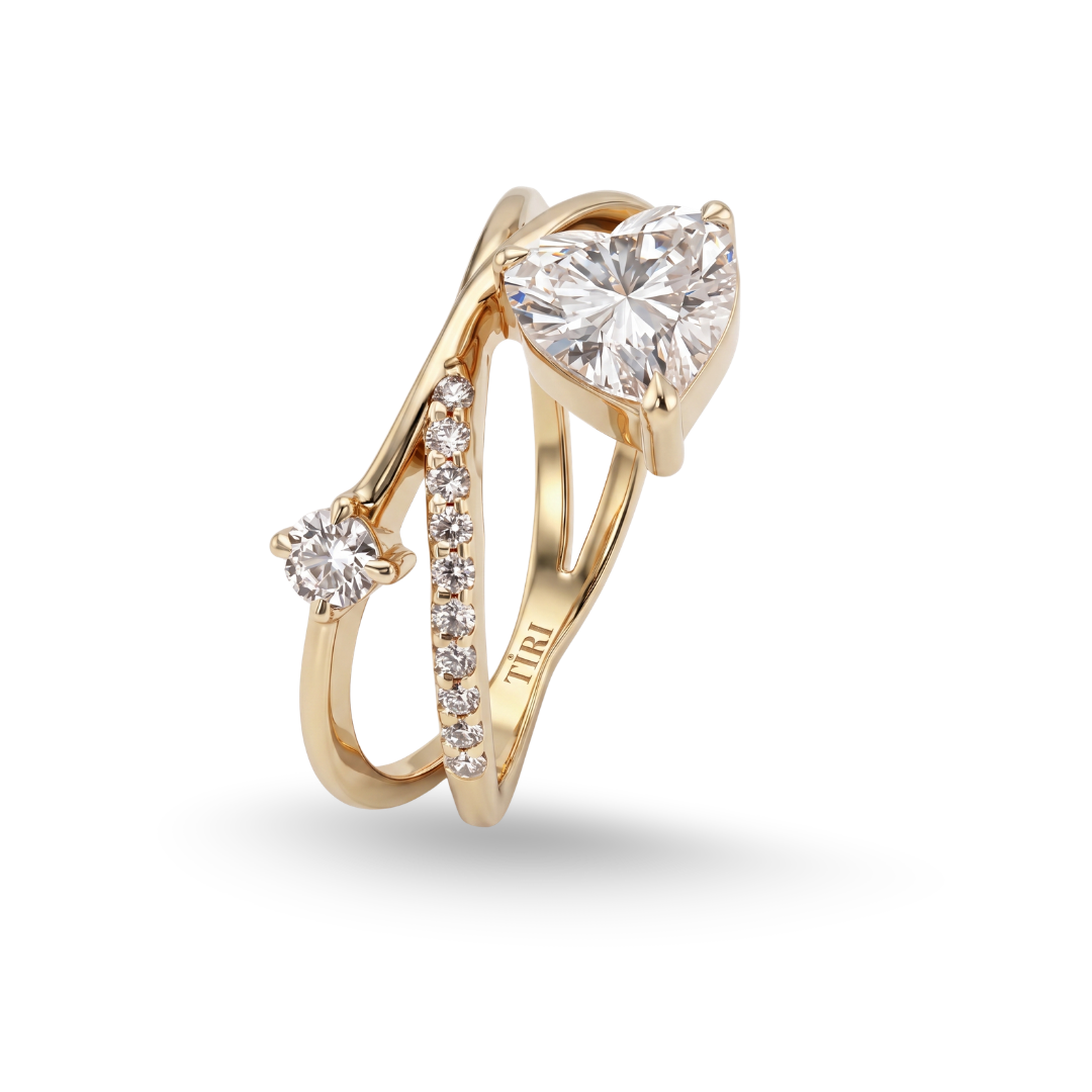 Tiri crossover heart-shaped diamond ring featuring intertwining bands and sparkling diamonds on a silver or white gold setting.