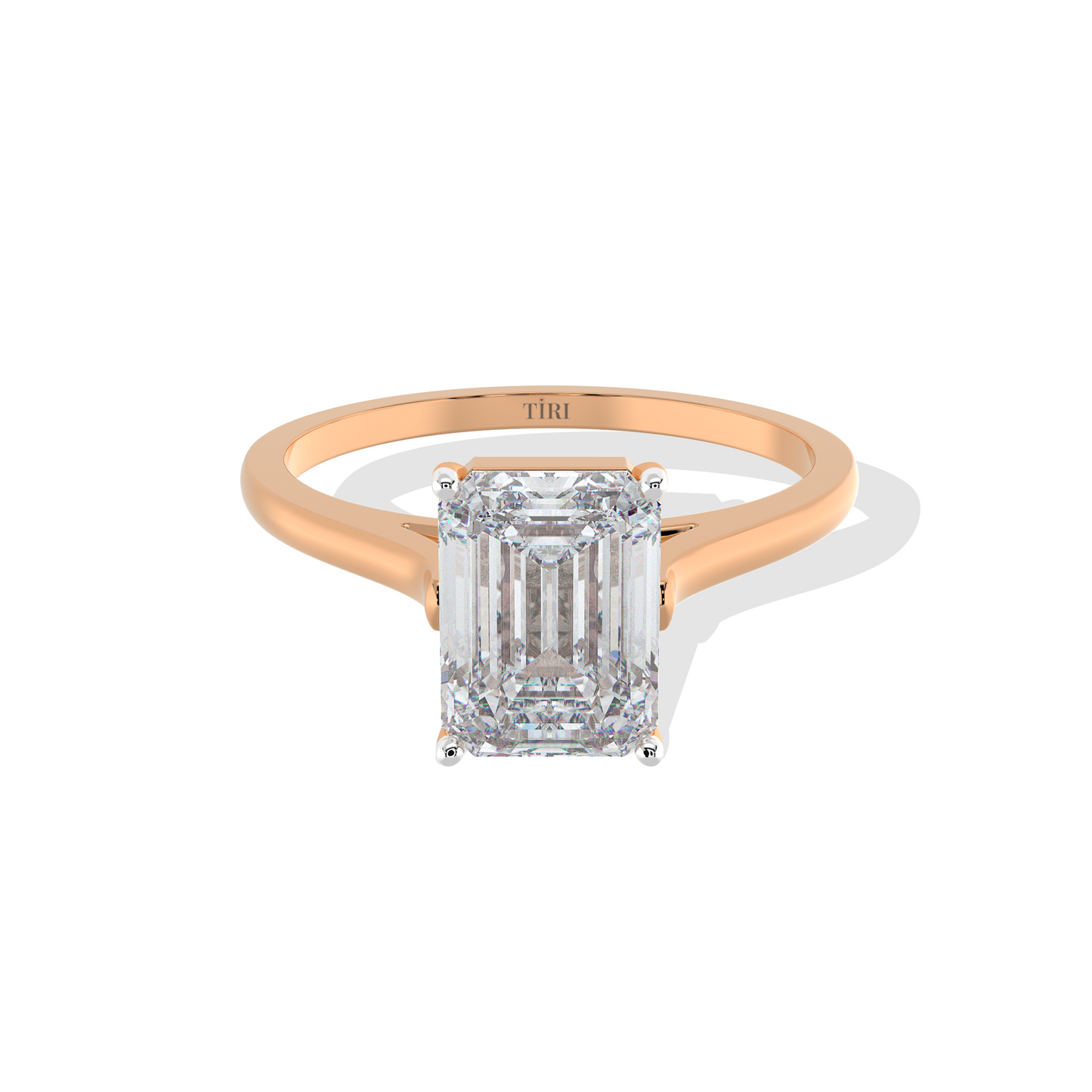 Emerald-cut solitaire diamond ring set in rose gold.