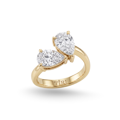 Tiri You-and-Me pear cut diamond ring featuring a central pear-shaped diamond and elegant band design.