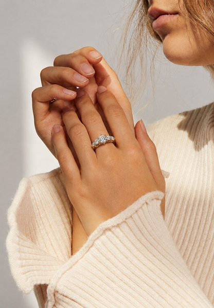 Tiri Valoria diamond ring featuring a sparkling central diamond set in a sleek, elegant band on a white background.
