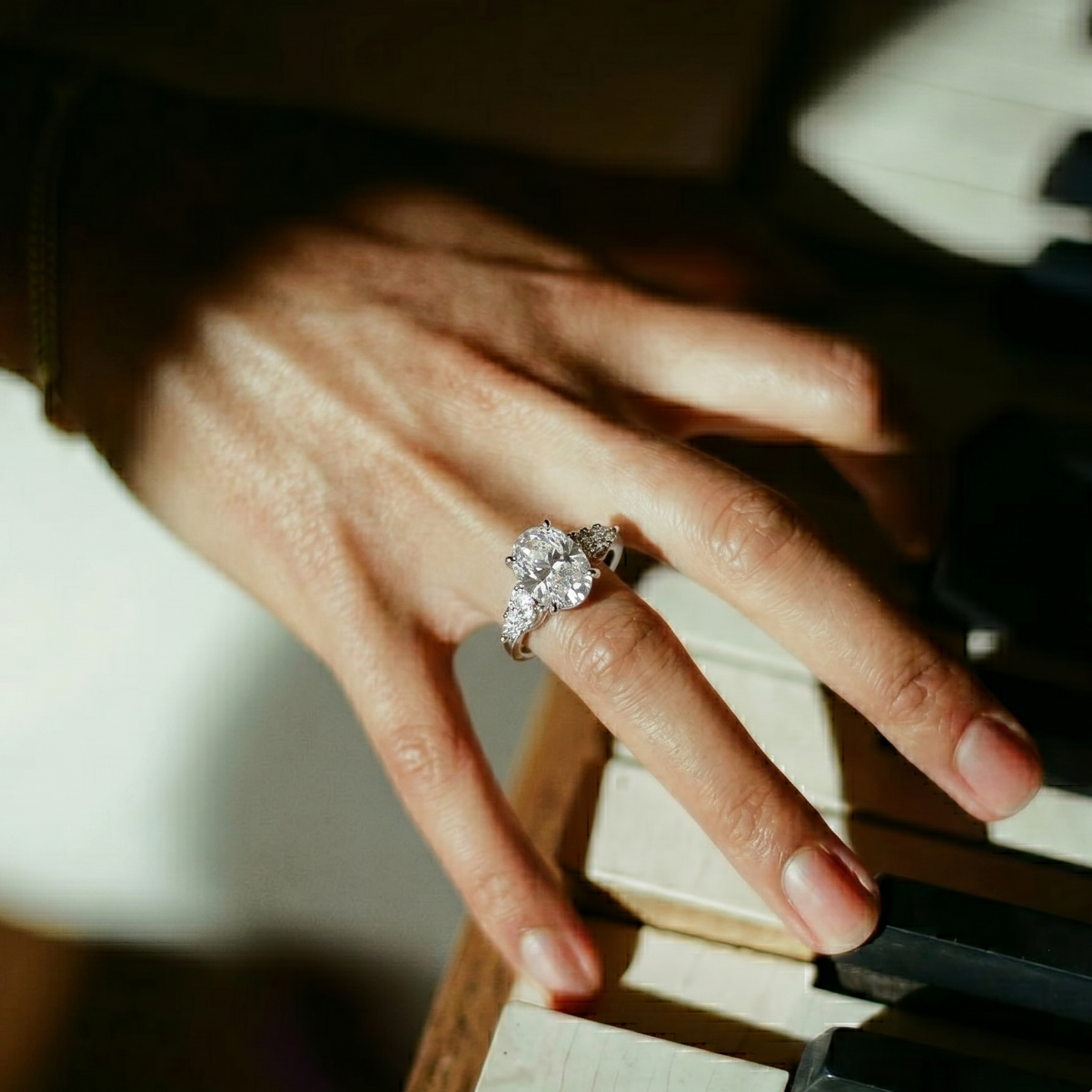 Hand with a ring playing a piano