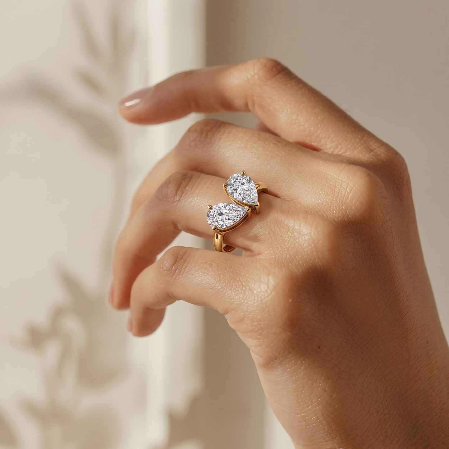 Tiri You-and-Me pear cut diamond ring featuring two intertwined pear-shaped diamonds on a sleek band.