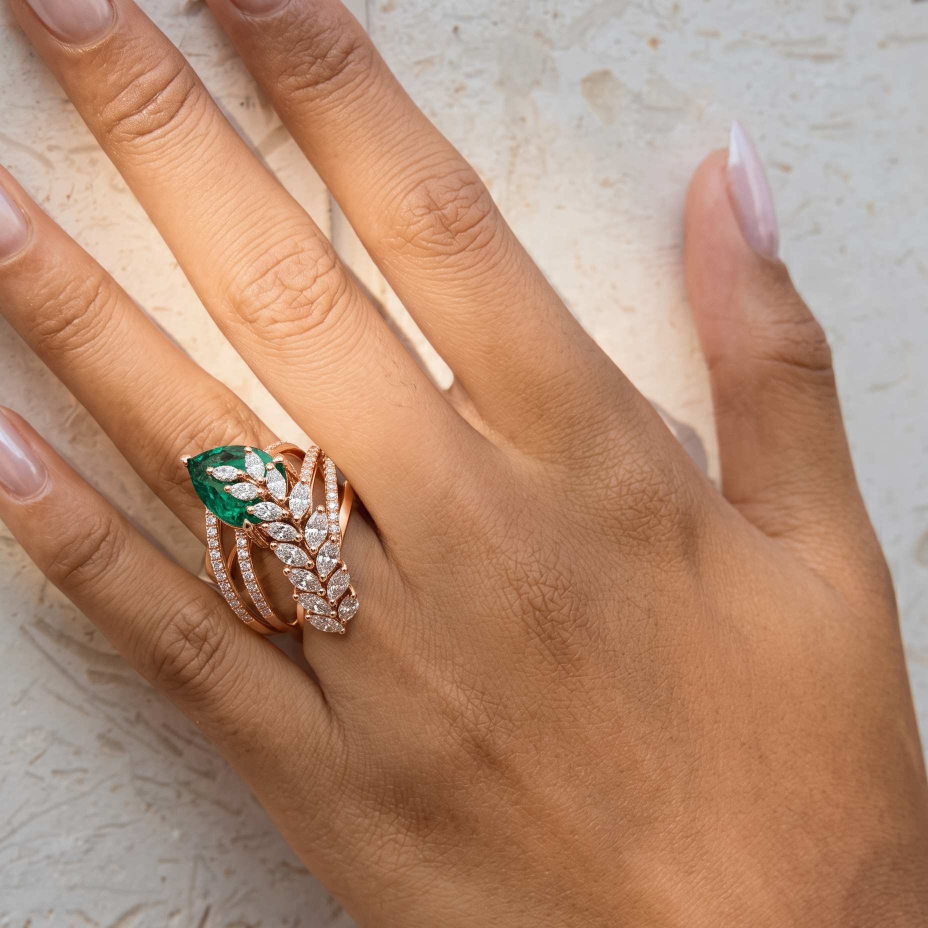 Elegant emerald foliage diamond ring by Tiri featuring intricate leaf design and sparkling diamonds on a gold band.