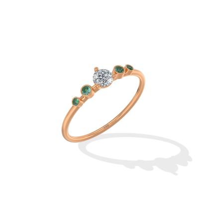 Tiri Avira Emerald Ring featuring a vibrant emerald gemstone set in a silver band with intricate detailing.