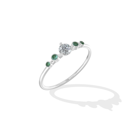 Tiri Avira Emerald Ring featuring a vibrant green emerald gemstone set in a delicate gold band.