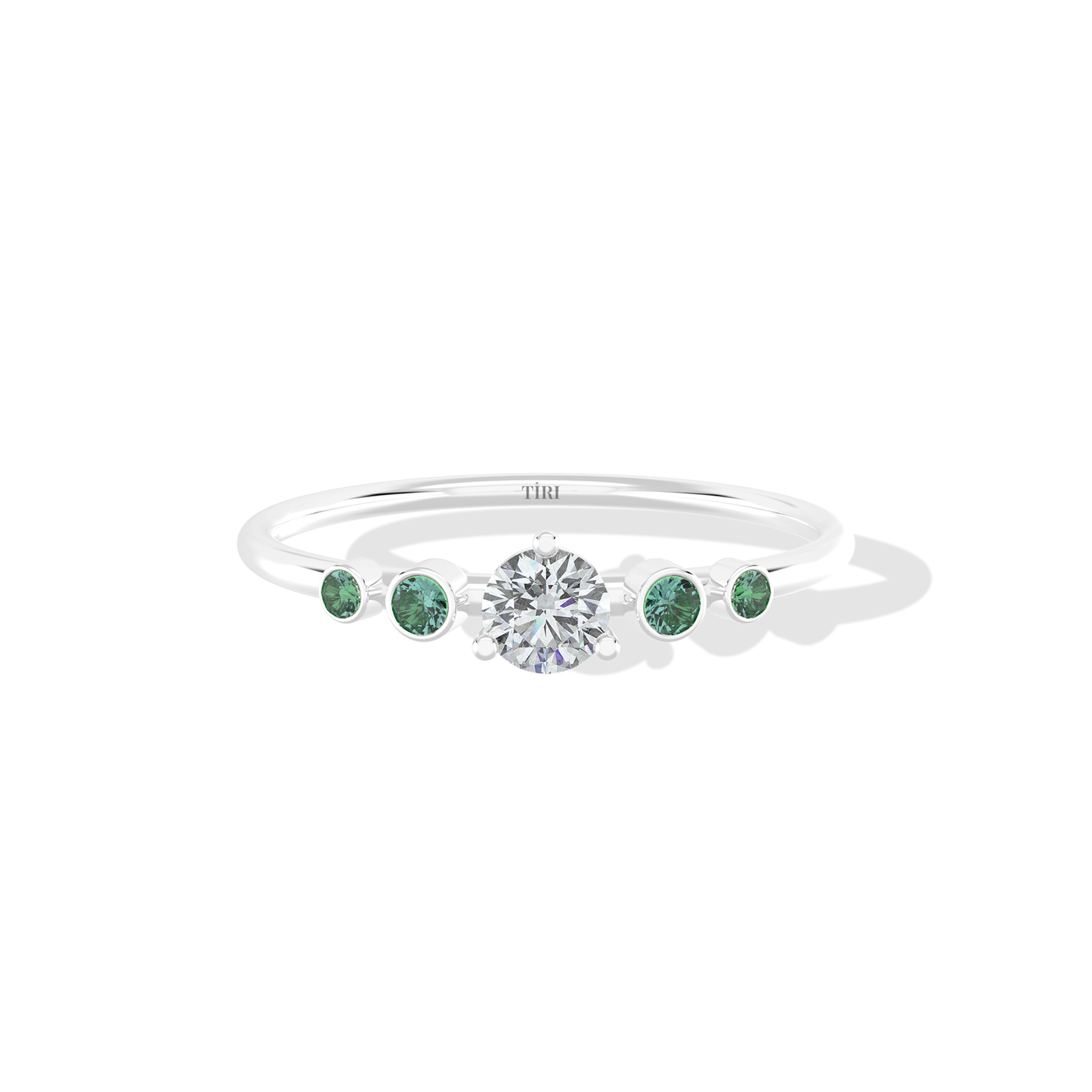 Tiri Avira Emerald Ring with a central emerald gemstone set in a silver band, showcasing intricate design details