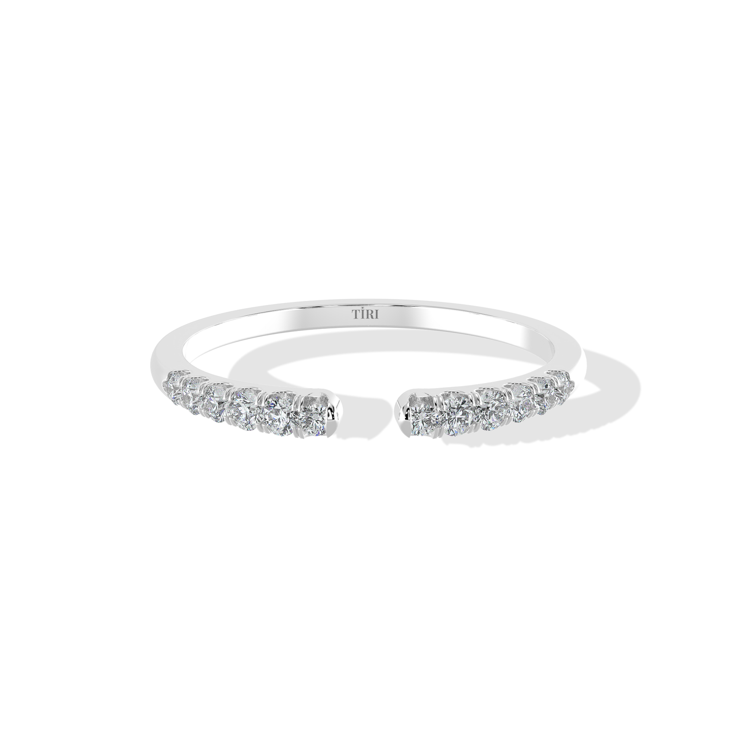 Elegant 0.20 TW diamond ring by Tiri featuring a sparkling diamond band with intricate design and polished finish.