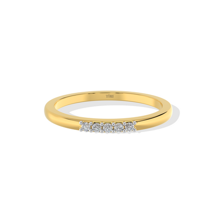 Yellow gold three-stone diamond ring featuring three round brilliant-cut stones. Classic trilogy engagement ring.