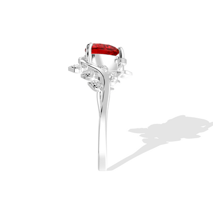 Heart-shaped red gemstone ring with diamond leaf accents.