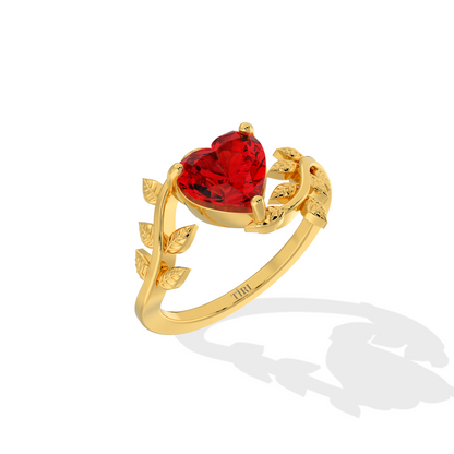 Heart-shaped red gemstone ring with diamond leaf accents.