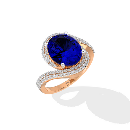 Elegant white gold ring featuring an oval blue gemstone with a twisted diamond-pavé band, photographed on a white background.