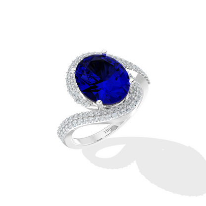 Silver ring with a blue gemstone on a white background