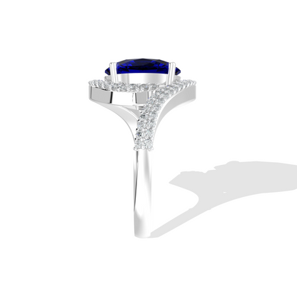 Elegant white gold ring featuring an oval blue gemstone with a twisted diamond-pavé band, photographed on a white background.