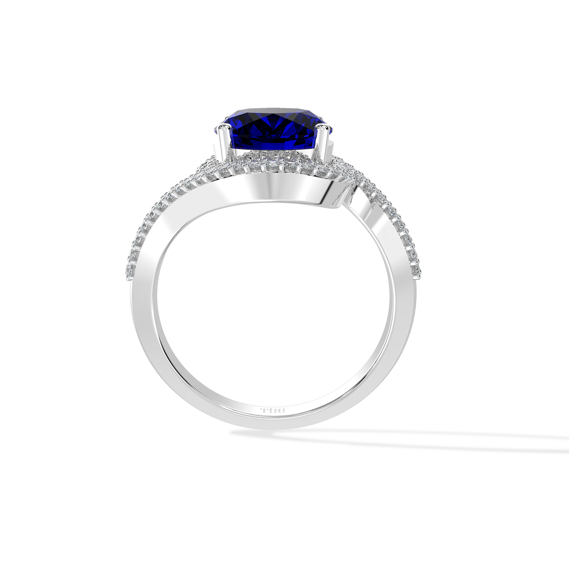 Elegant white gold ring featuring an oval blue gemstone with a twisted diamond-pavé band, photographed on a white background.