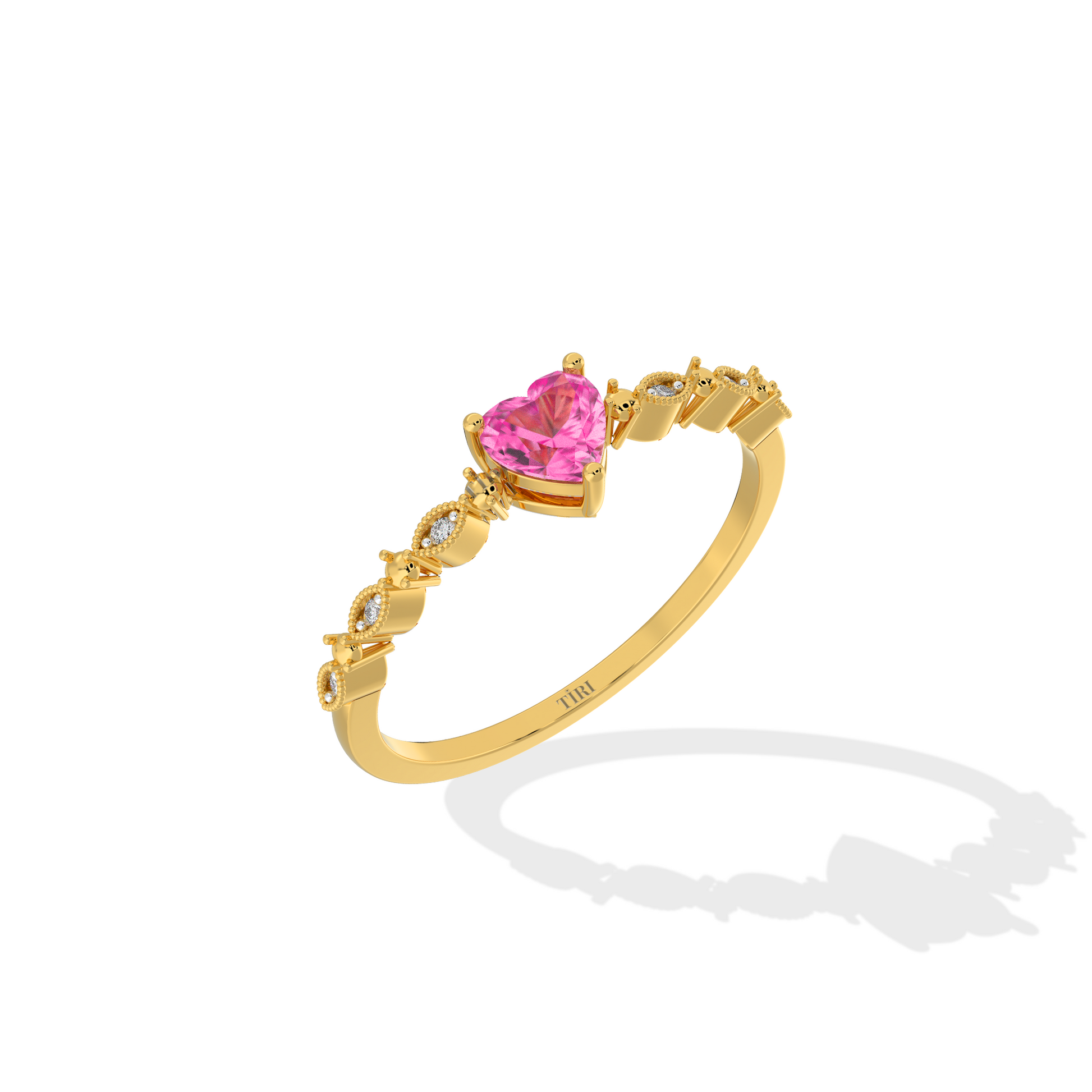 Gold ring with a pink heart-shaped gemstone on a white background
