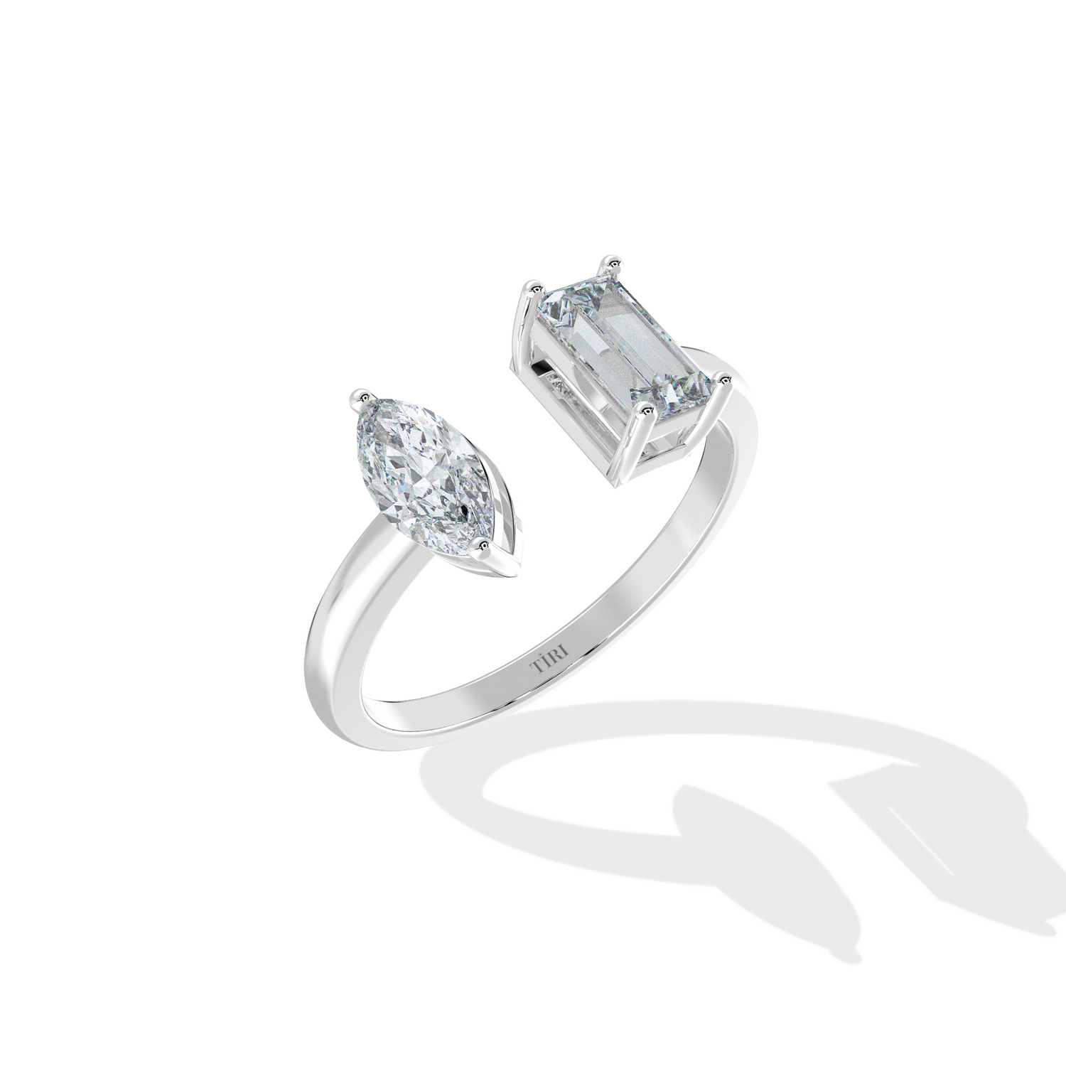 Emerald and marquise Toi Moi ring by Tiri featuring a central emerald gemstone and marquise-shaped accents on a gold band