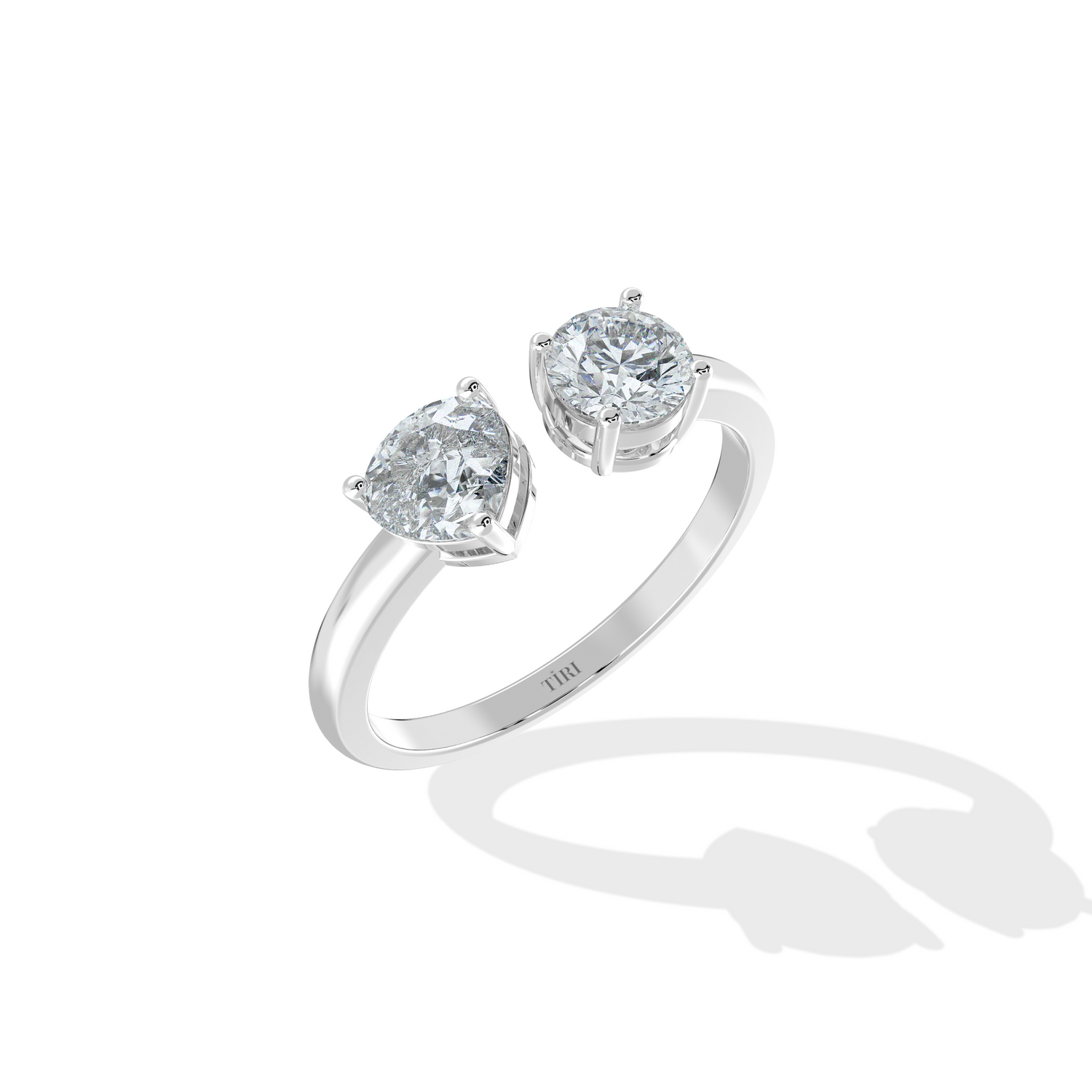 Modern white gold open-cuff diamond ring, featuring round brilliant and trillion cut diamond settings