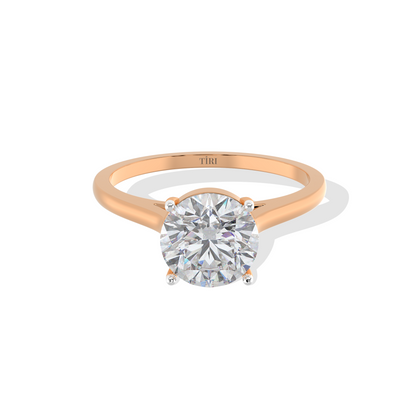 Round-cut solitaire diamond ring set in rose gold.