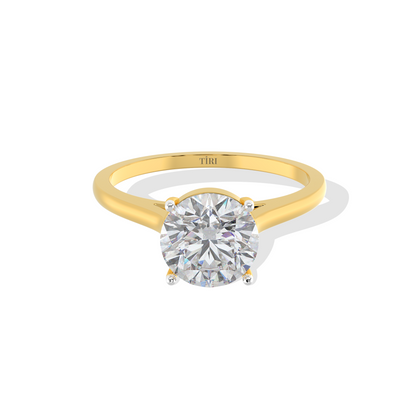 Round-cut solitaire diamond ring set in yellow gold.
