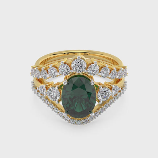 Luxury gold ring featuring an oval deep green gemstone with a halo of round diamonds and a split diamond band, photographed on a white background