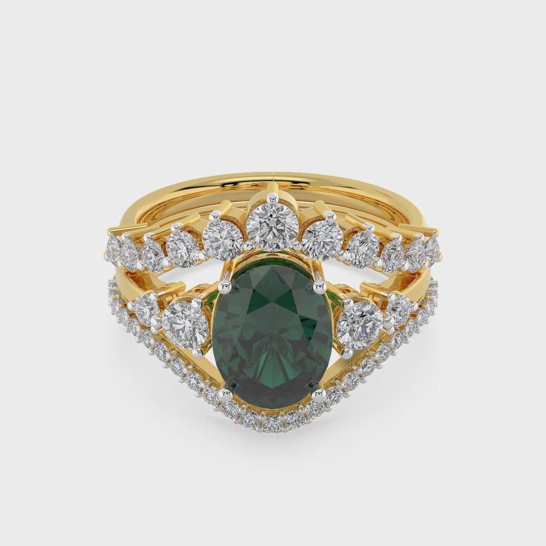 Luxury gold ring featuring an oval deep green gemstone with a halo of round diamonds and a split diamond band, photographed on a white background