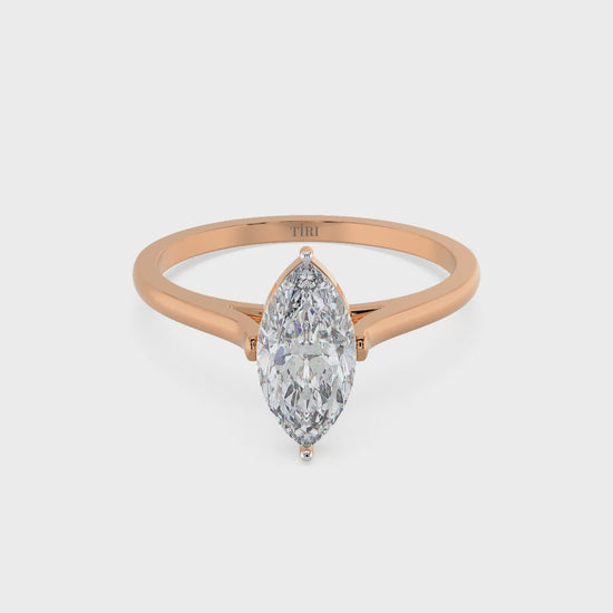 Marquise diamond ring in rose gold setting with delicate band, ideal for engagement or wedding