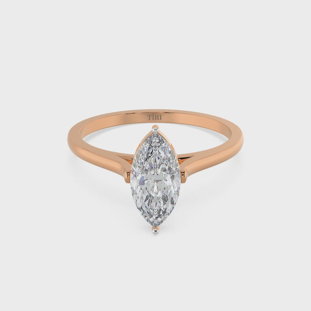 Marquise diamond ring in rose gold setting with delicate band, ideal for engagement or wedding