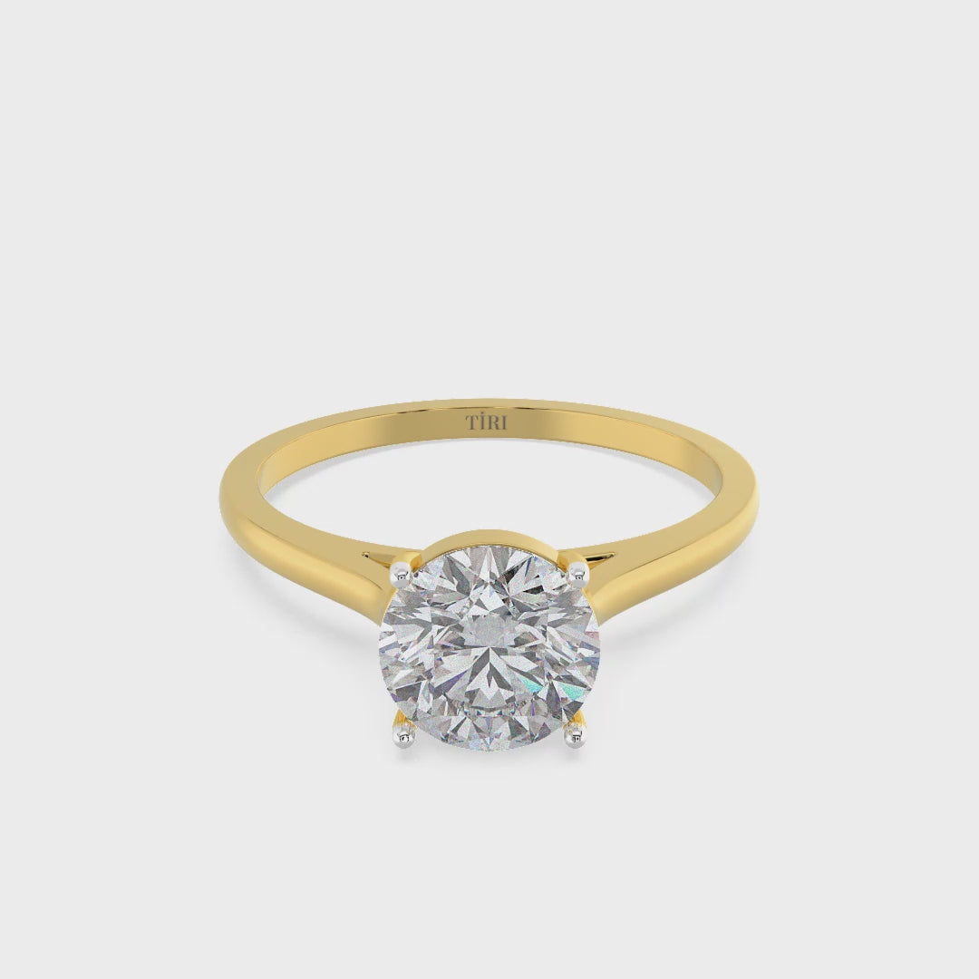 Round-cut solitaire diamond ring set in yellow gold