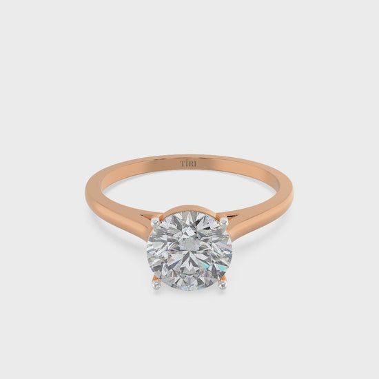 Round-cut solitaire diamond ring set in rose gold.