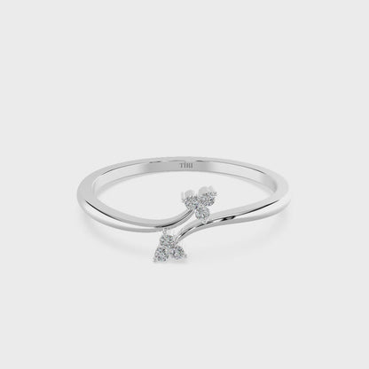 White gold oval diamond engagement ring set horizontally (East-West setting) with a halo of accent stones and a pave band