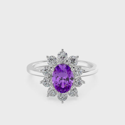 Silver ring with a purple gemstone on a white background