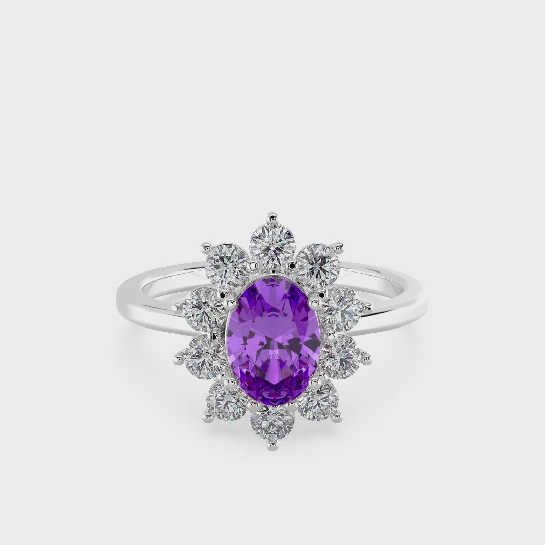 Silver ring with a purple gemstone on a white background