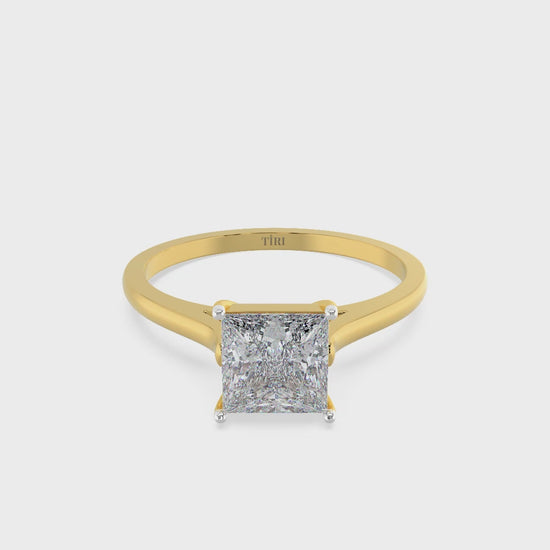 Princess-cut diamond solitaire engagement ring in yellow gold.