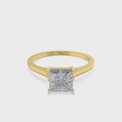 Princess-cut diamond solitaire engagement ring in yellow gold.