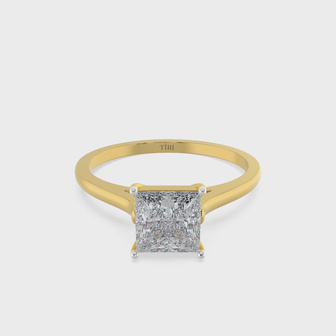 Princess-cut diamond solitaire engagement ring in yellow gold.