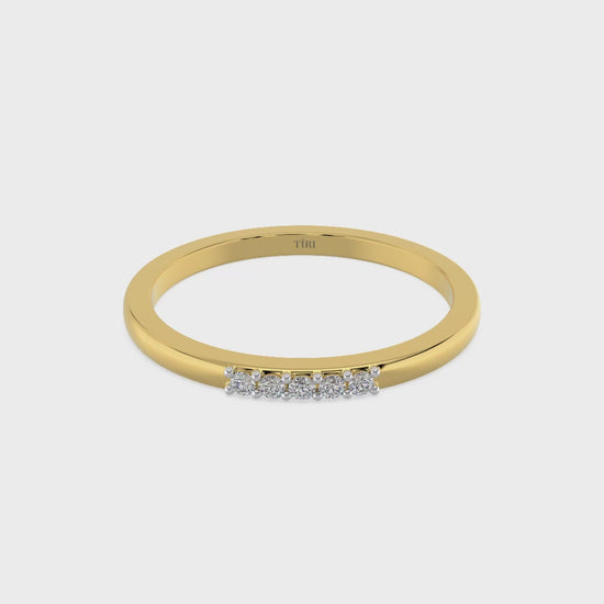 Yellow gold three-stone diamond ring featuring three round brilliant-cut stones. Classic trilogy engagement ring.